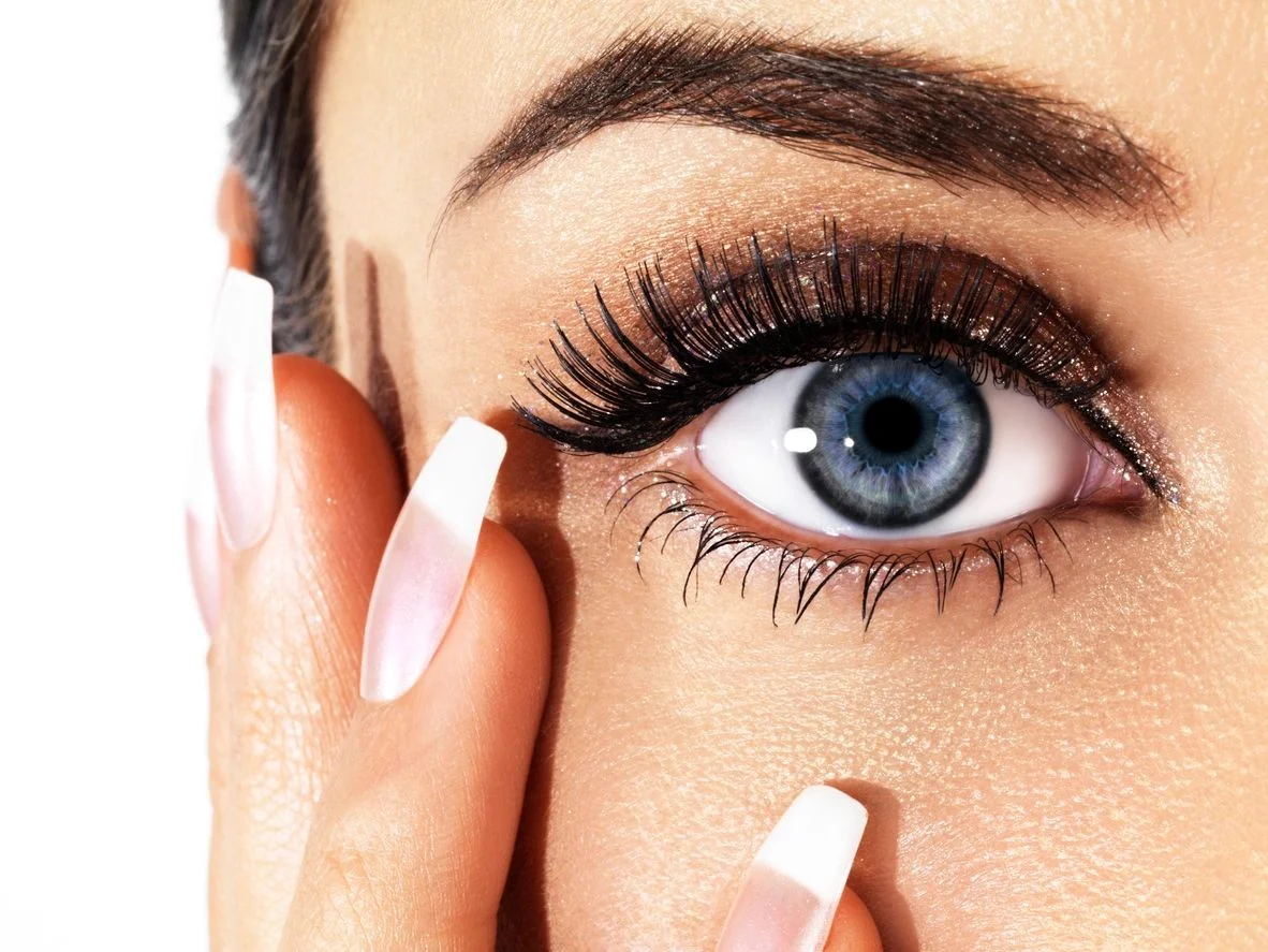 Close view of a woman touching the skin beneath her eye