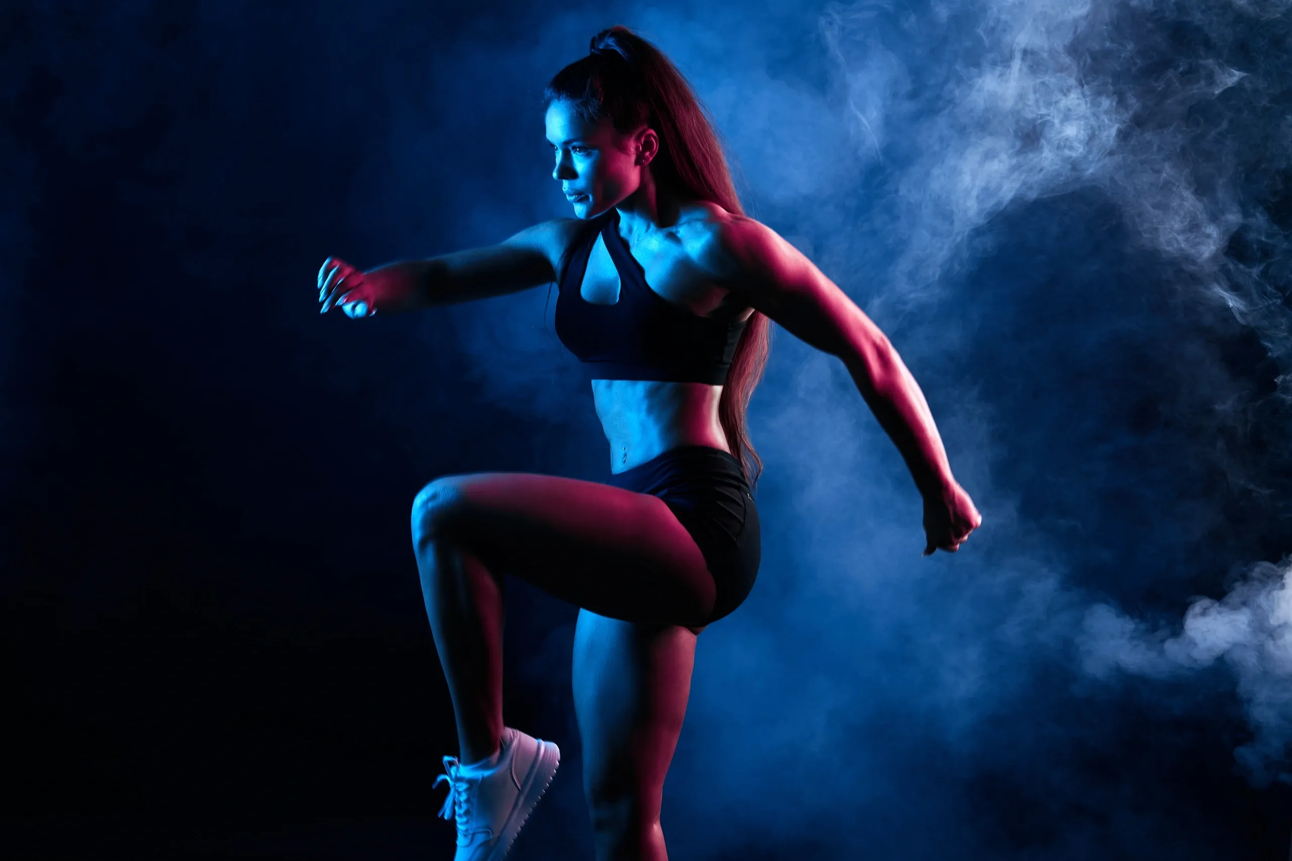 Woman exercising in an athletic setting